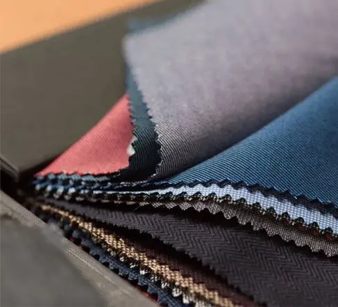 A close up of several different colored fabrics.