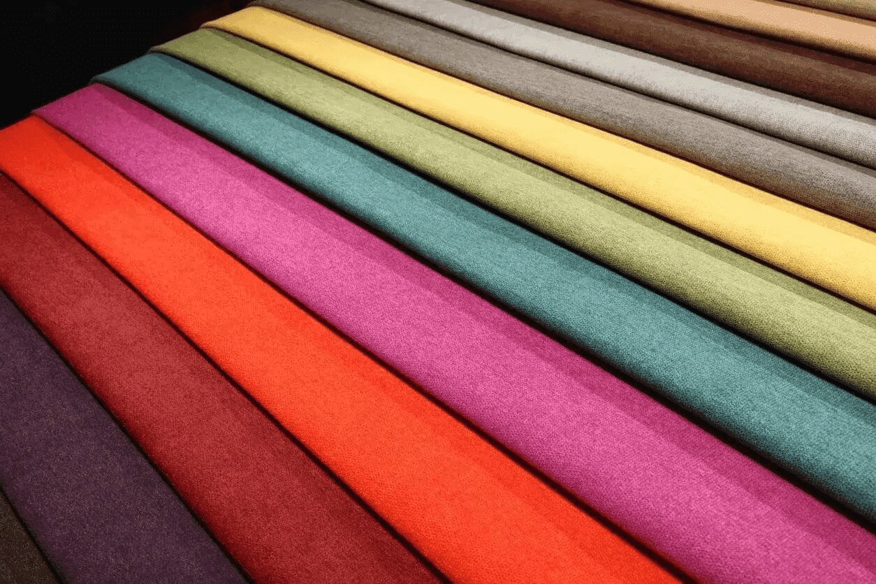 A close up of many different colored fabrics